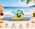 A rolled beach towel with blue and white stripes and a cartoon coconut character on the label, placed on a sandy beach with ocean and palm trees in the background. The image includes promotional text and feature icons for the towel.